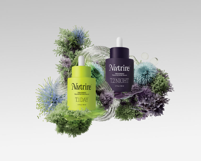 Two Nutrire skincare bottles, one green and one purple, surrounded by decorative flowers on a light gray background.